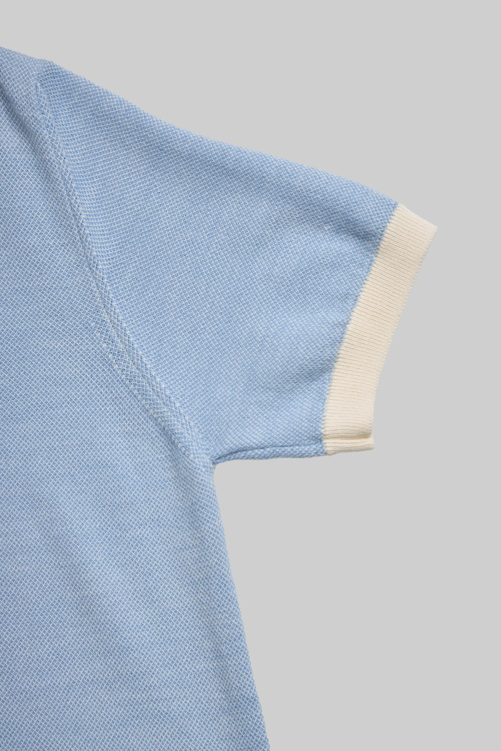 Light blue knit polo shirt with contrast collar 
